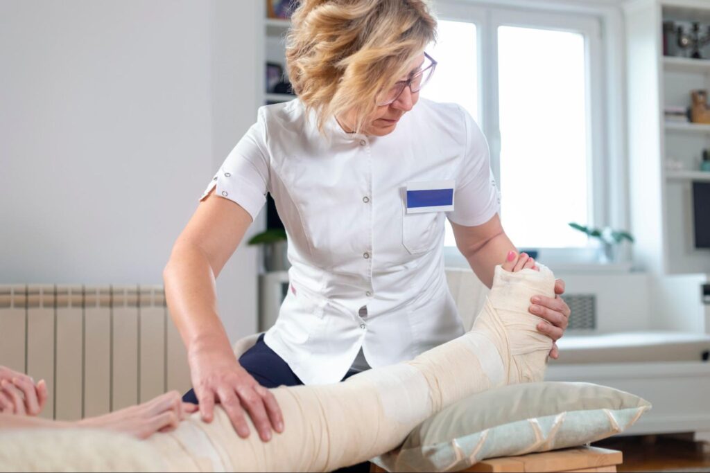 doctor looking at leg injury