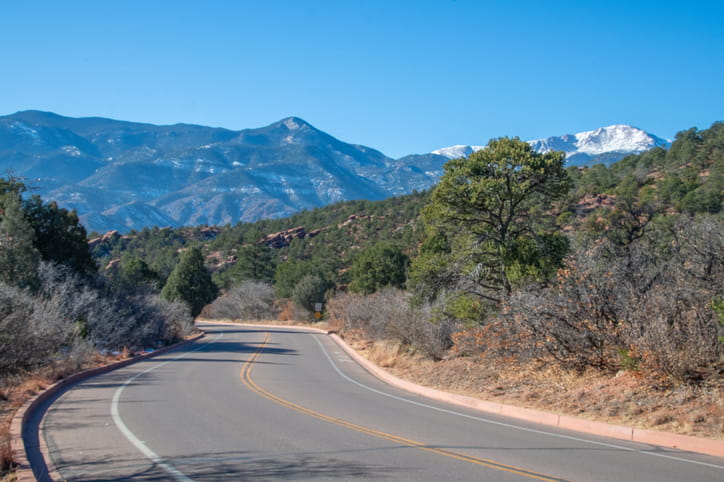 An empty road through sandstone formations in the Garden of the Gods in Colorado Springs, Colorado.