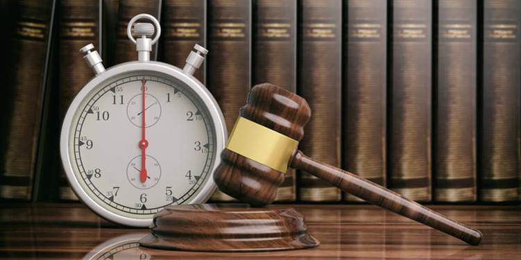 A stopwatch next to a wooden gavel.